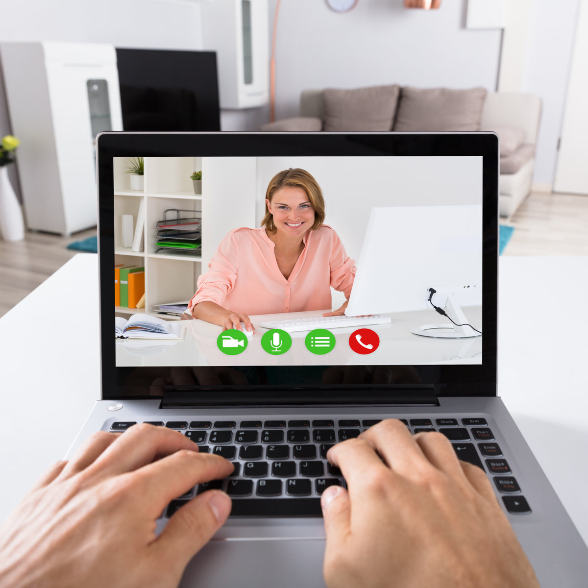Close-up Of A Person Video Conferencing With Smiling Woman On Laptop